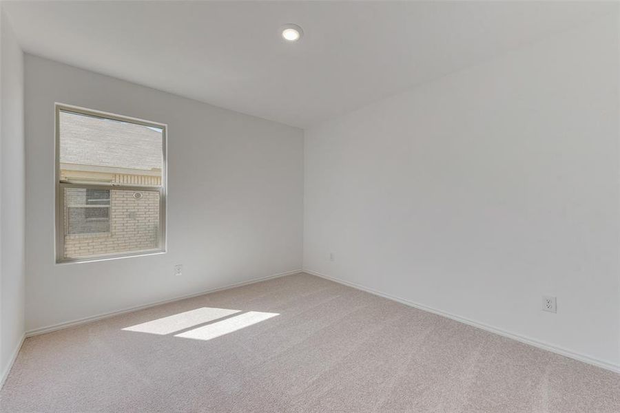 Empty room featuring light colored carpet