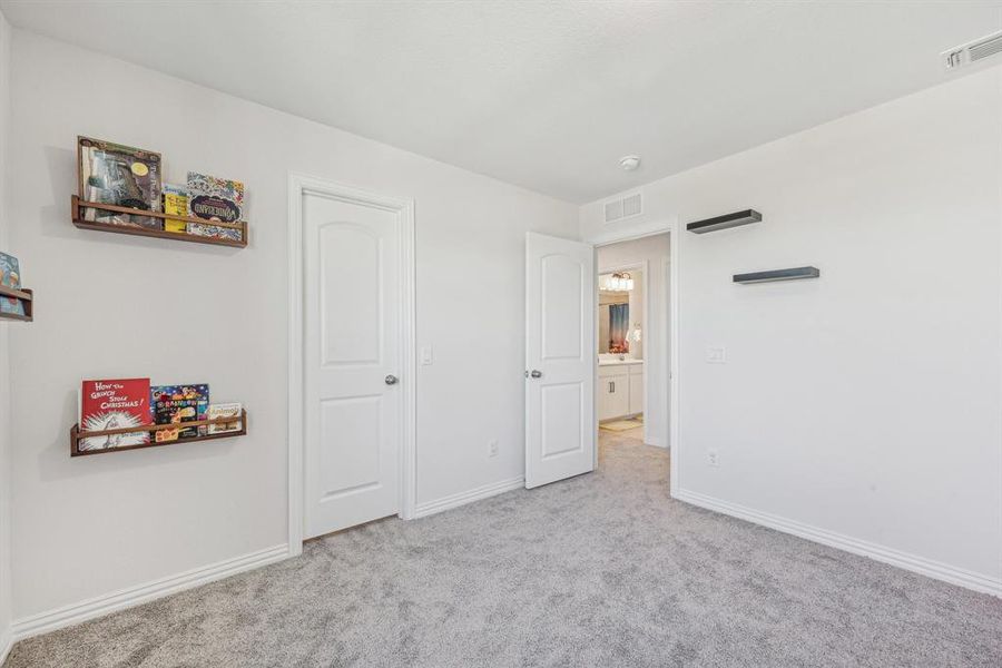 Unfurnished bedroom with light colored carpet