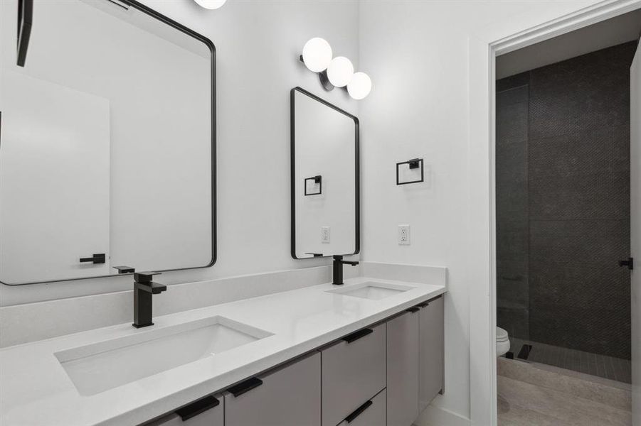 Bathroom with double vanity and toilet