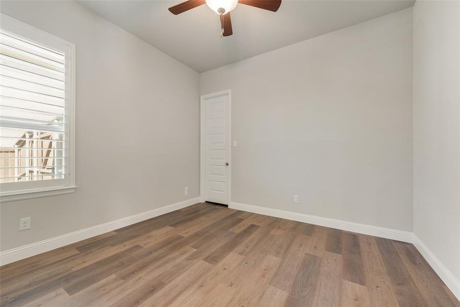 Bedroom featuring wood-type flooring and ceiling fan