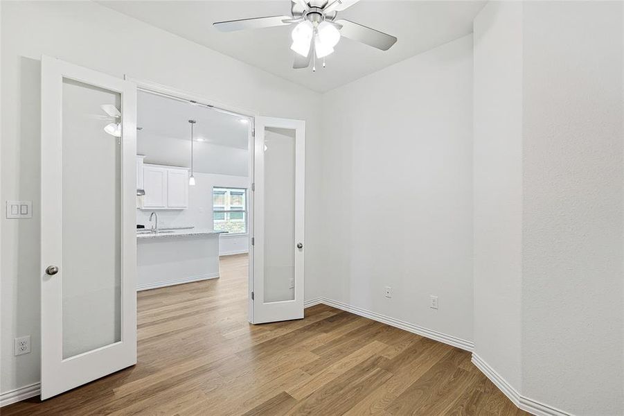 Spare room with light hardwood / wood-style floors, ceiling fan, and sink