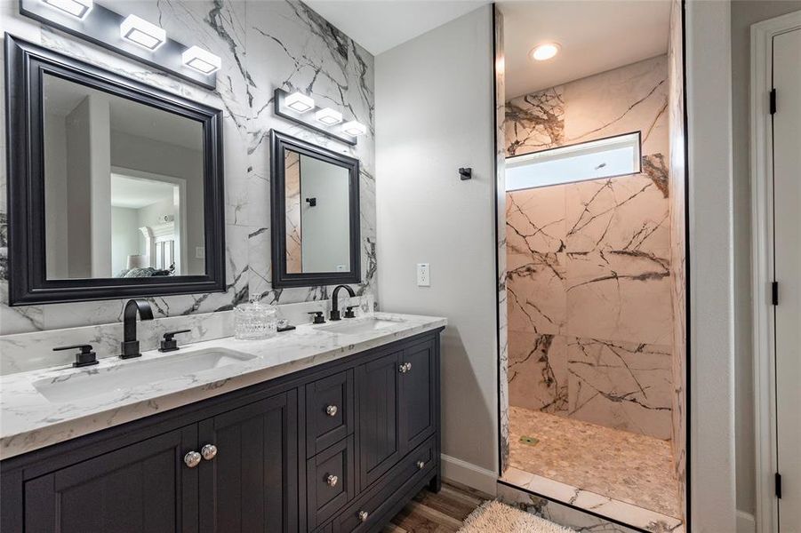 All three full baths are adorned with luxurious marble tile walk-in showers and dual vanities featuring LED lighting. Experience spa-like relaxation and elegance in every bathroom!