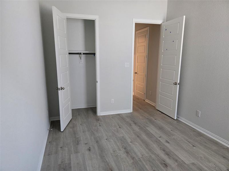 Unfurnished bedroom featuring light wood-type flooring and a closet