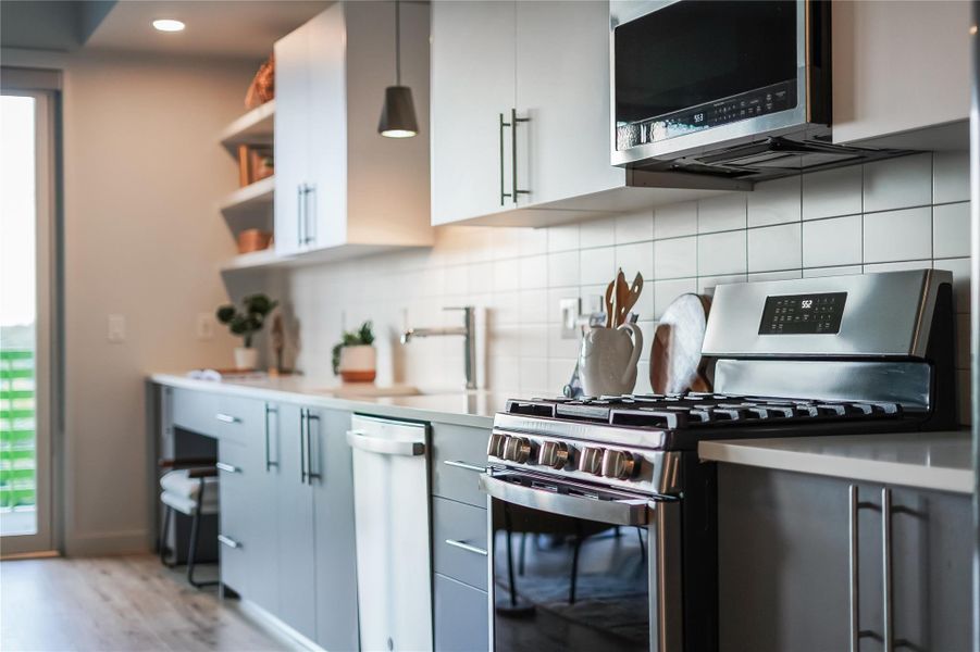 Beautiful modern kitchen with quartz countertops and stainless appliances.