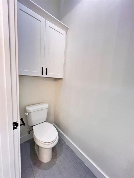 A bright white toilet area.