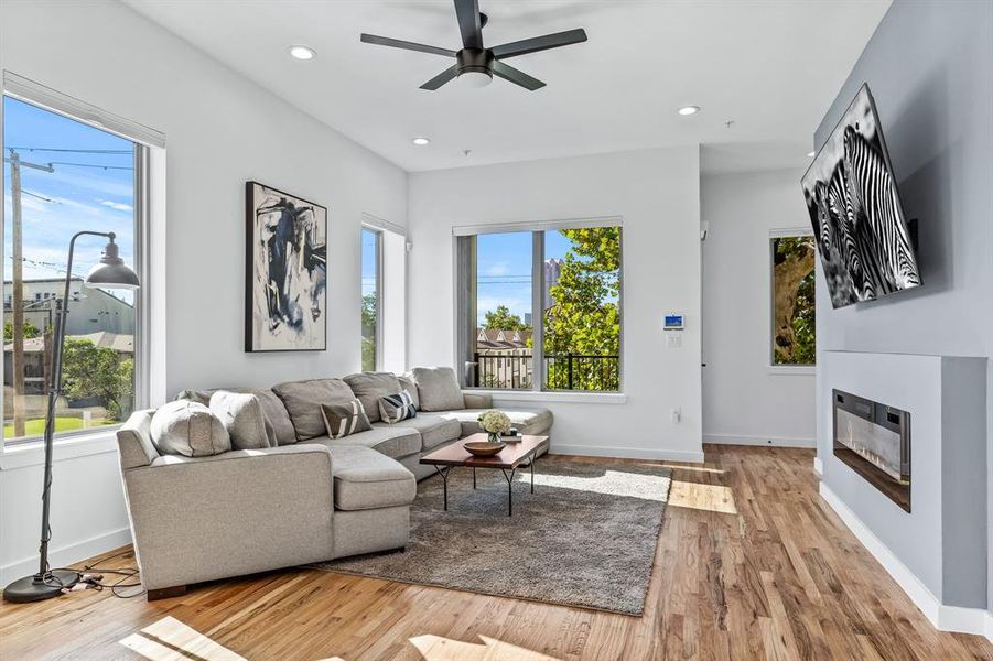 Living room featuring light wood flooring, and plenty of natural light