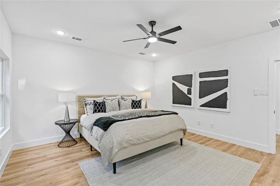 Bedroom with light hardwood / wood-style floors and ceiling fan