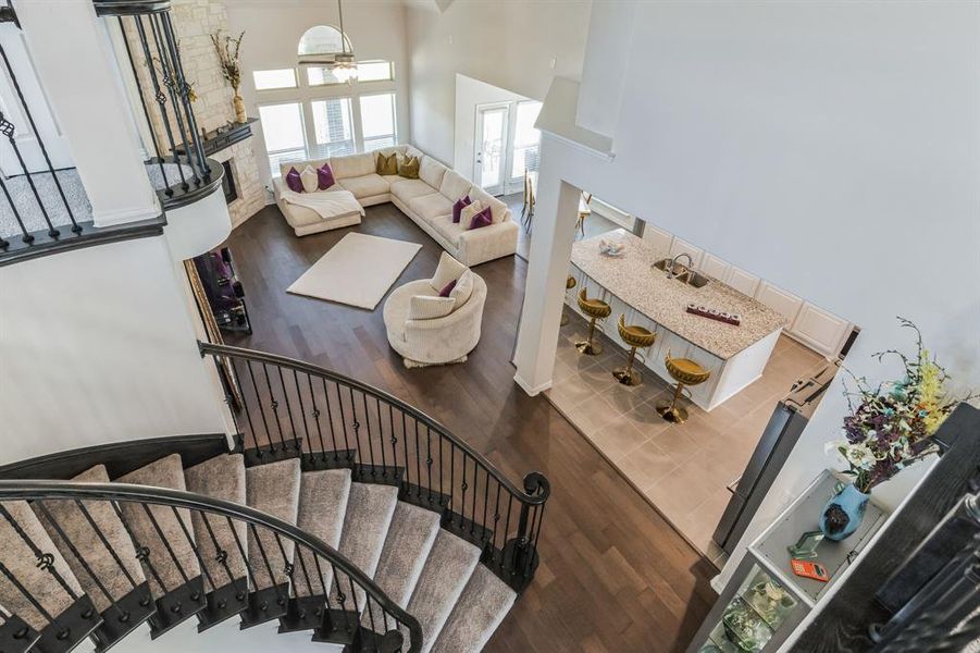 Stairs featuring a high ceiling and hardwood / wood-style floors