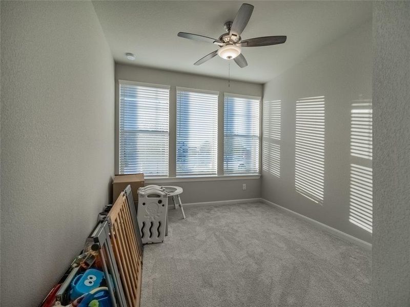 bedroom 3 also has large windows and ceiling fan