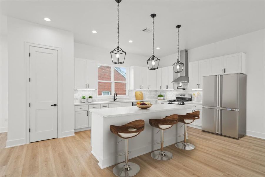 Virtually Staged: Masterfully equipped kitchen featuring a large island, beautiful tile backsplash, under cabinet lighting and outlets, granite countertops, soft close cabinets and drawers, and pot filler.