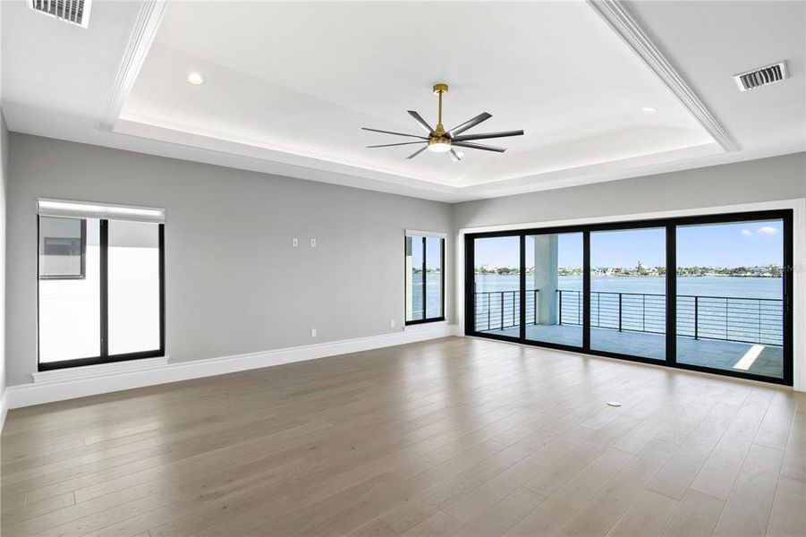 3rd level family room and covered balcony with water views