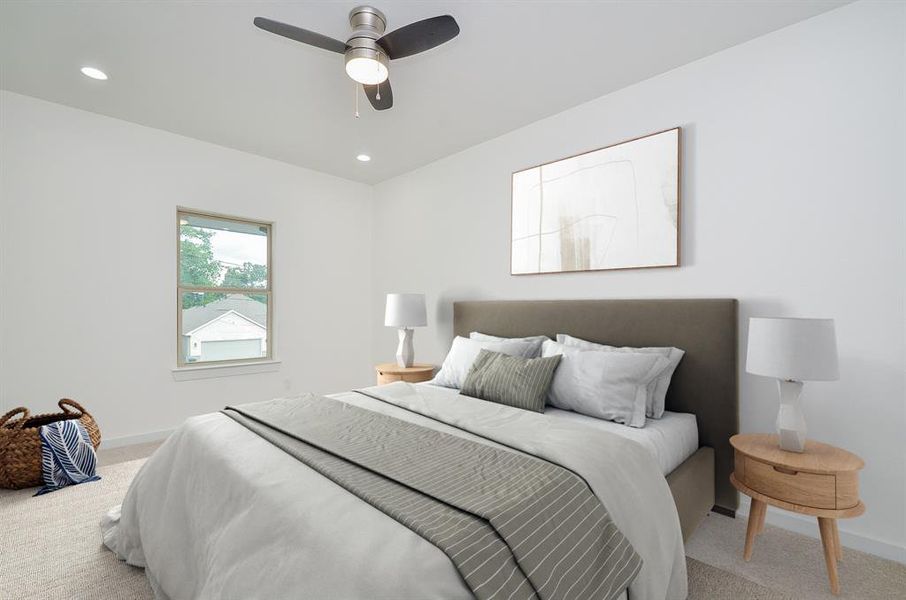 The second of the secondary bedrooms, this room boasts a neutral palette of carpets and walls, views of the front of the home and ample closet space.