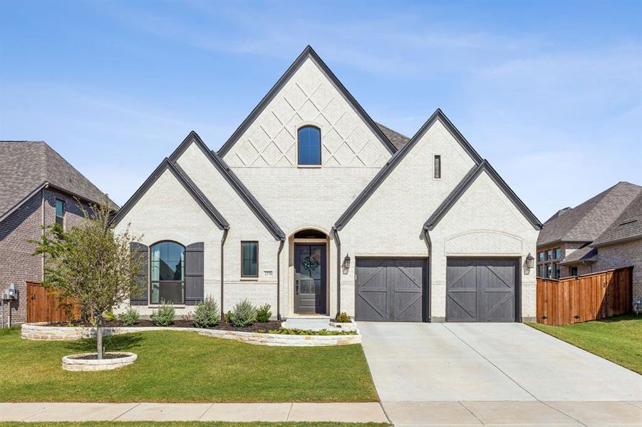 French country style house featuring a front yard