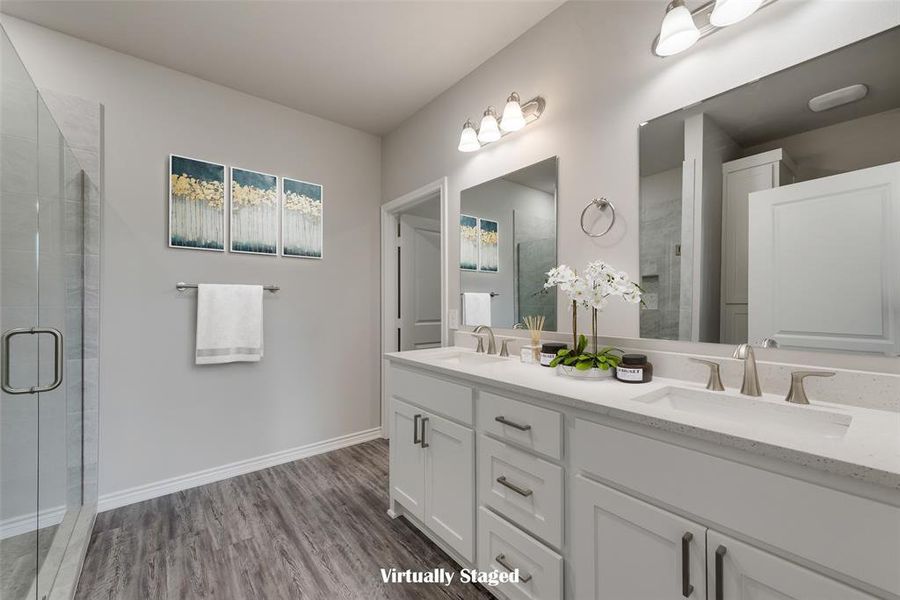 Bathroom featuring an enclosed shower, hardwood / wood-style flooring, and vanity