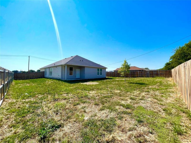 Back of house featuring a large wide yard