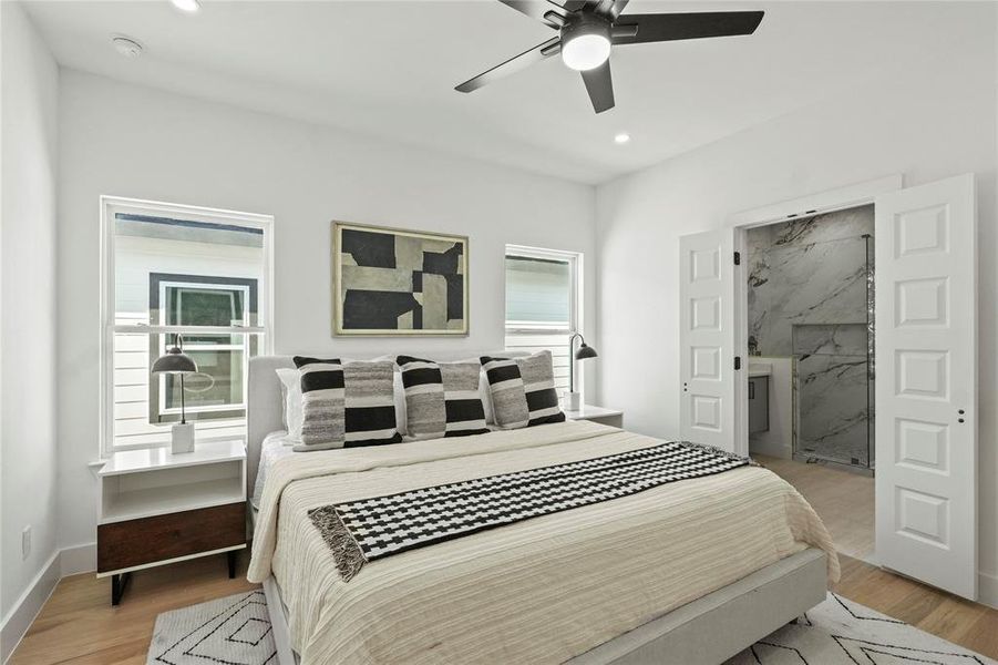 Bedroom with ceiling fan and light wood-type flooring