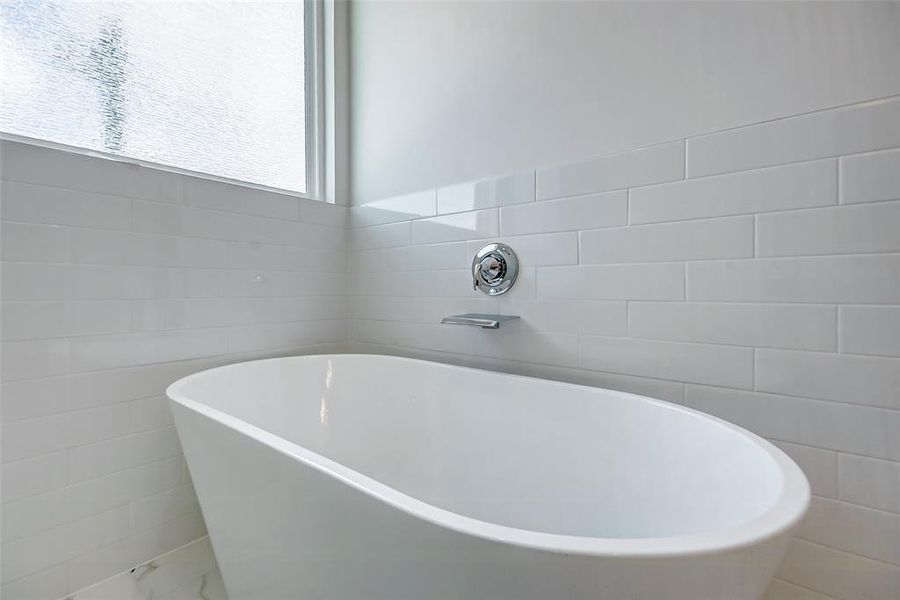 Oversized tub with tile surrounding