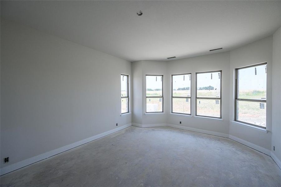 Empty room featuring concrete flooring and plenty of natural light
