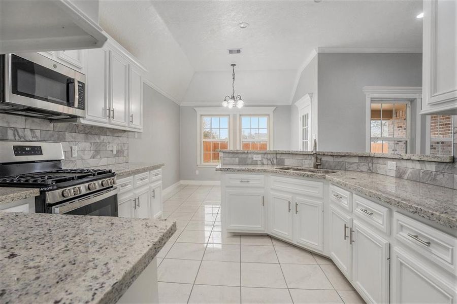 Kitchen looking into breakfast area