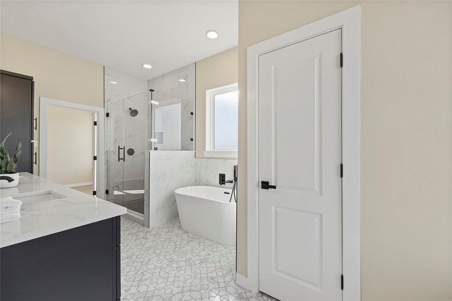 Bathroom featuring vanity, tile patterned floors, and plus walk in shower