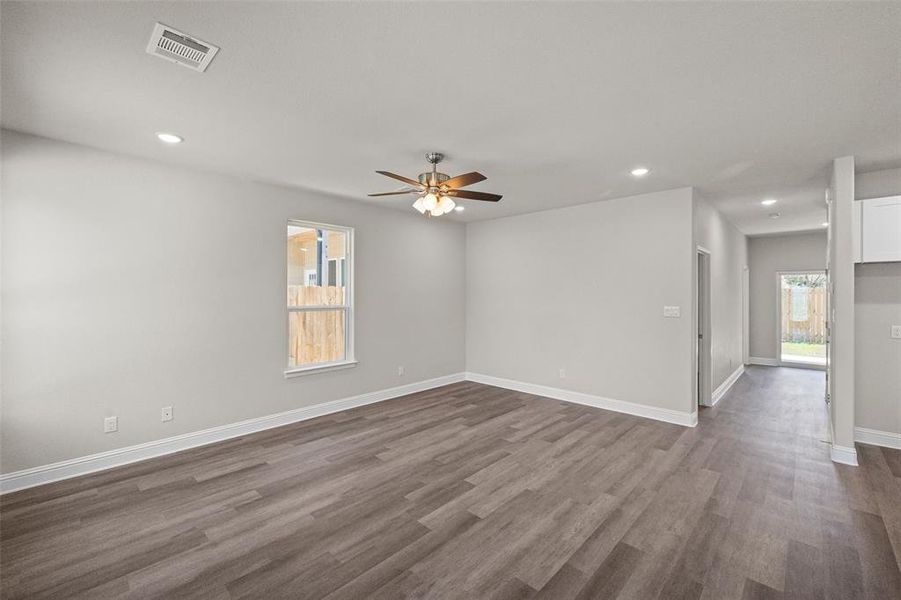Room featuring dark wood-type flooring and ceiling fan