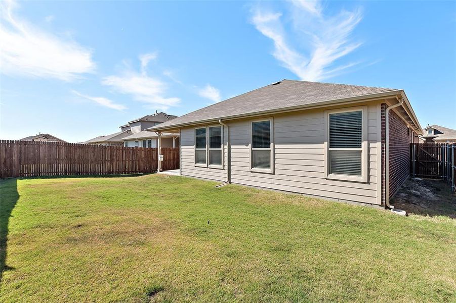 Rear view of house featuring a yard