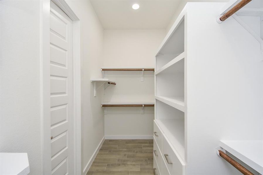 Your dream closet awaits with a custom closet system that you must see to believe. Varying height hanging rods, shelves, and drawers provide ample space for all your clothes and accessories.