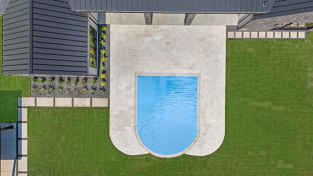 View of pool with a lawn