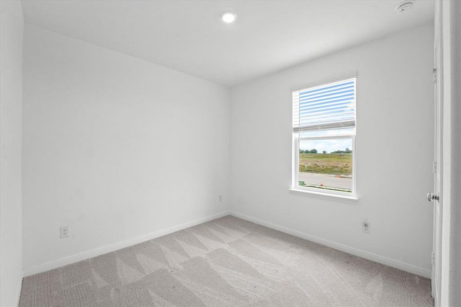 Unfurnished room featuring light carpet