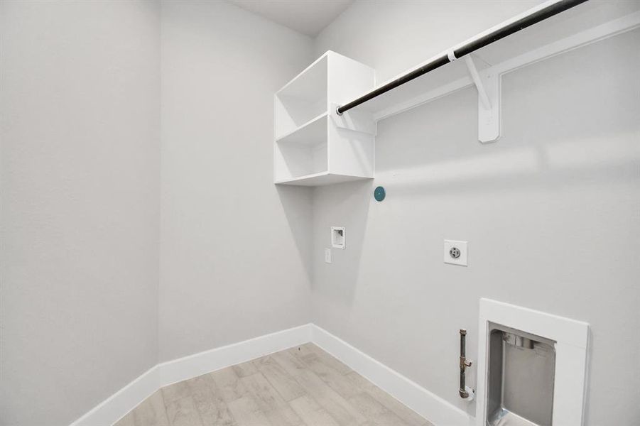 A perfect blend of functionality and comfort. Laundry room, thoughtfully equipped with shelving for effortless organization. Both gas and electric connections available.