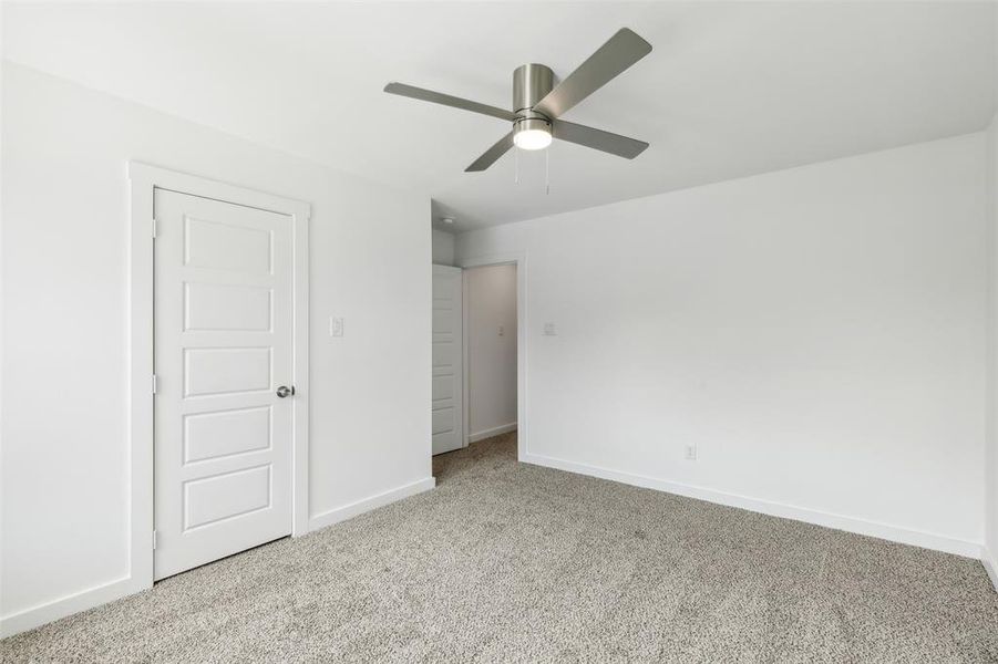Unfurnished bedroom with carpet flooring and ceiling fan