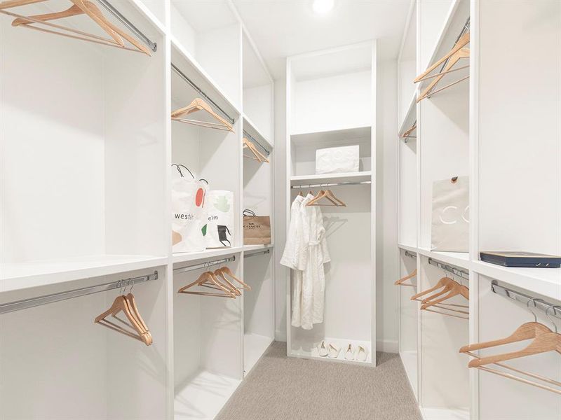 Large walk in closet with built-ins and storage.