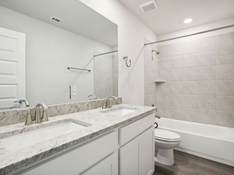 This full guest bathroom makes getting ready easier for everyone.