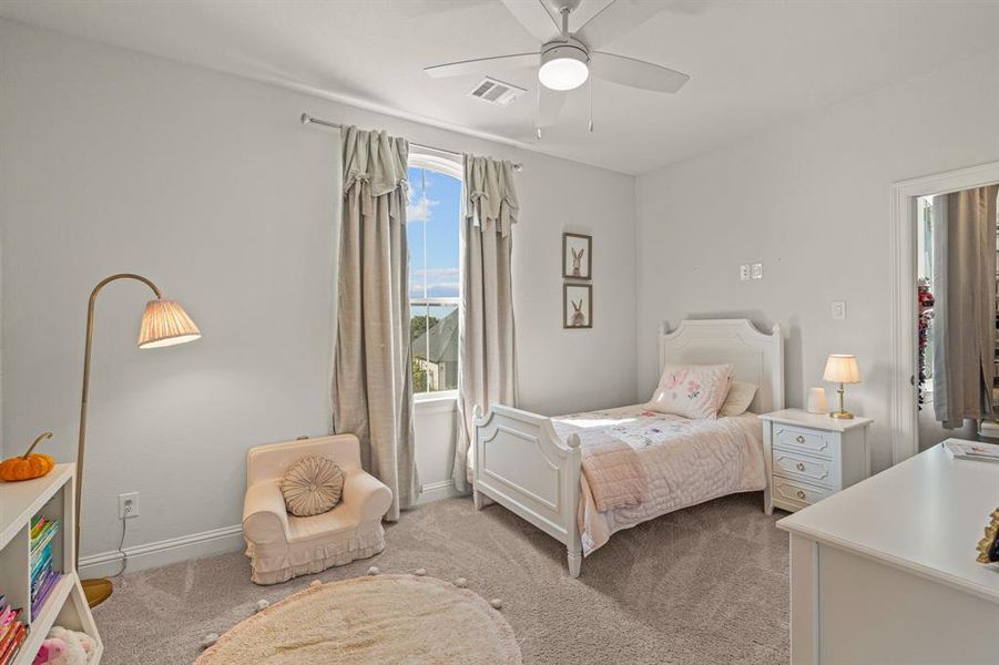 Bedroom with light carpet and ceiling fan