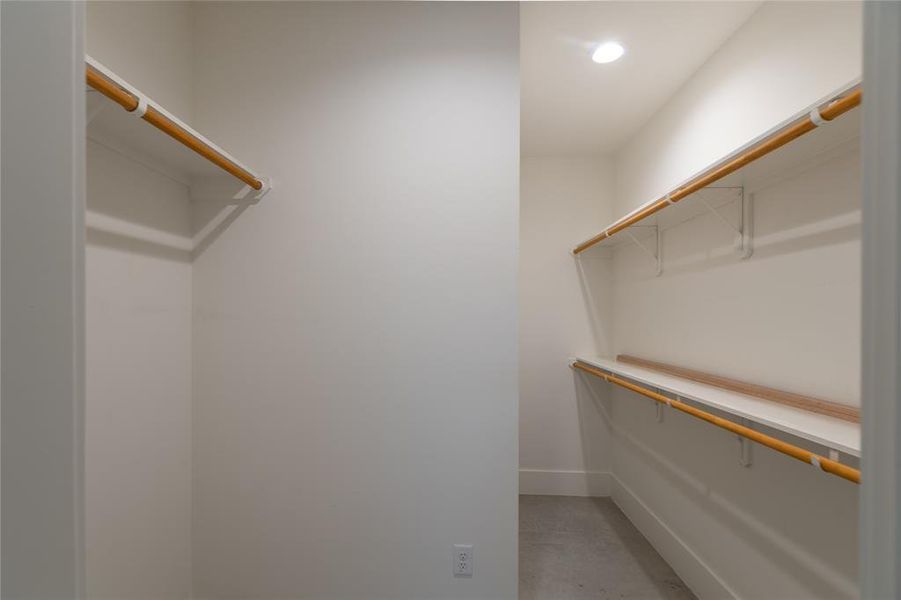 Huge walk-in closet with built-in shelving.