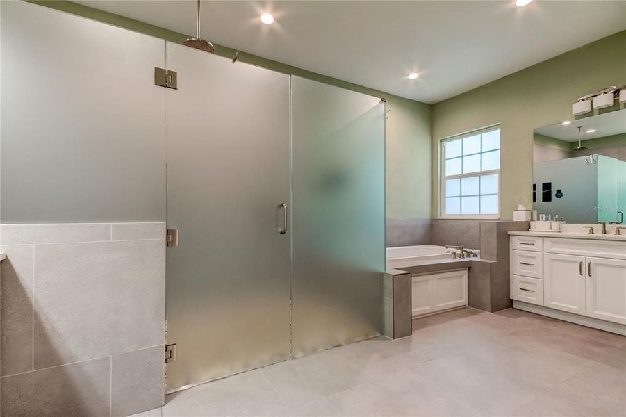 Primary bath, with zero-entry shower, dual shower heads, jetted garden tub, second vanity