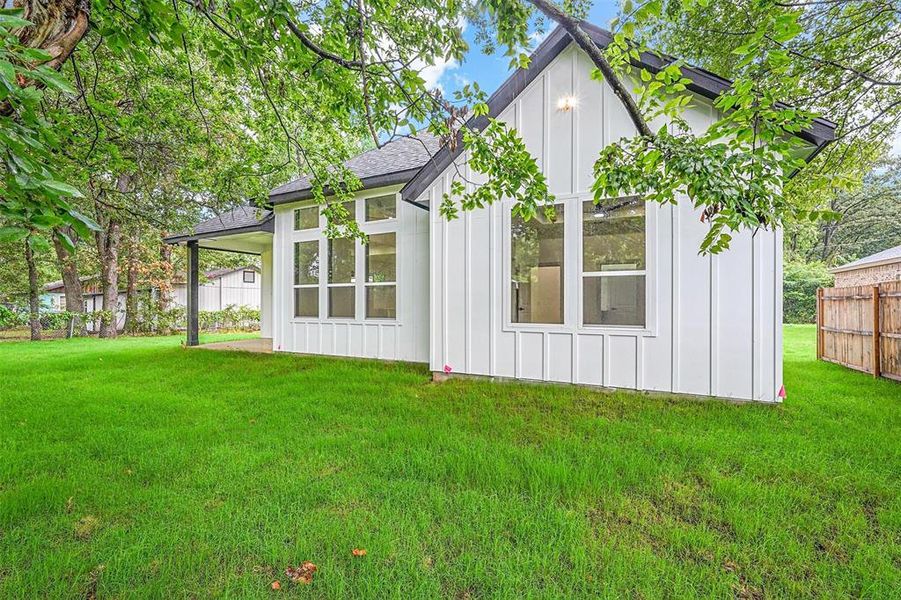 View of property exterior with a yard