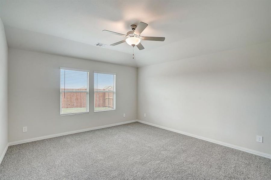 Bedroom with ceiling fan and carpeted floors