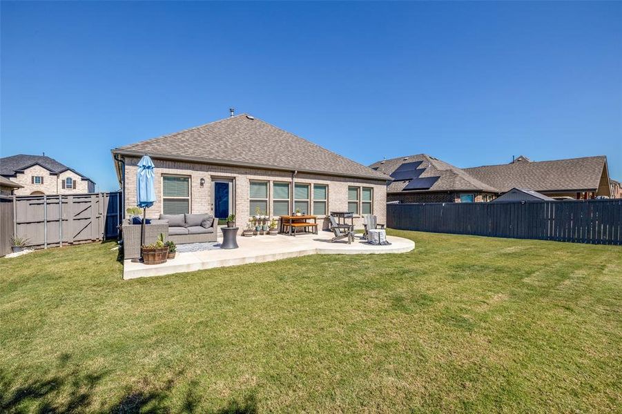 Rear view of property with a lawn, a patio, and outdoor lounge area