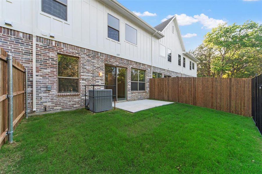 Rear view of property featuring a patio and a lawn