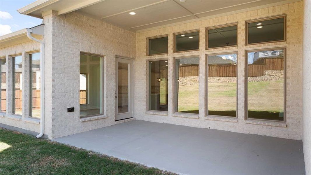 View of exterior entry featuring a patio area