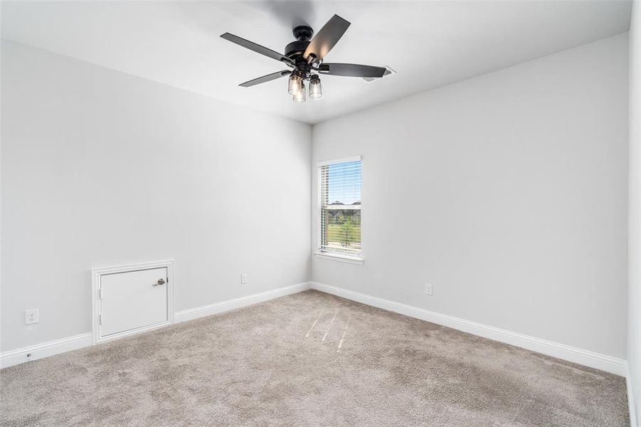 Unfurnished room featuring carpet floors and ceiling fan