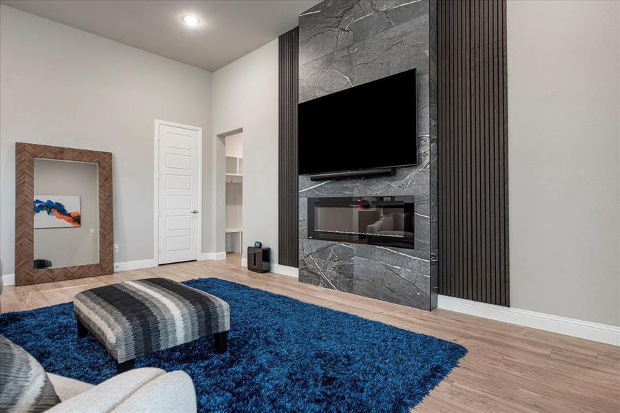 Living room with a fireplace and hardwood / wood-style flooring