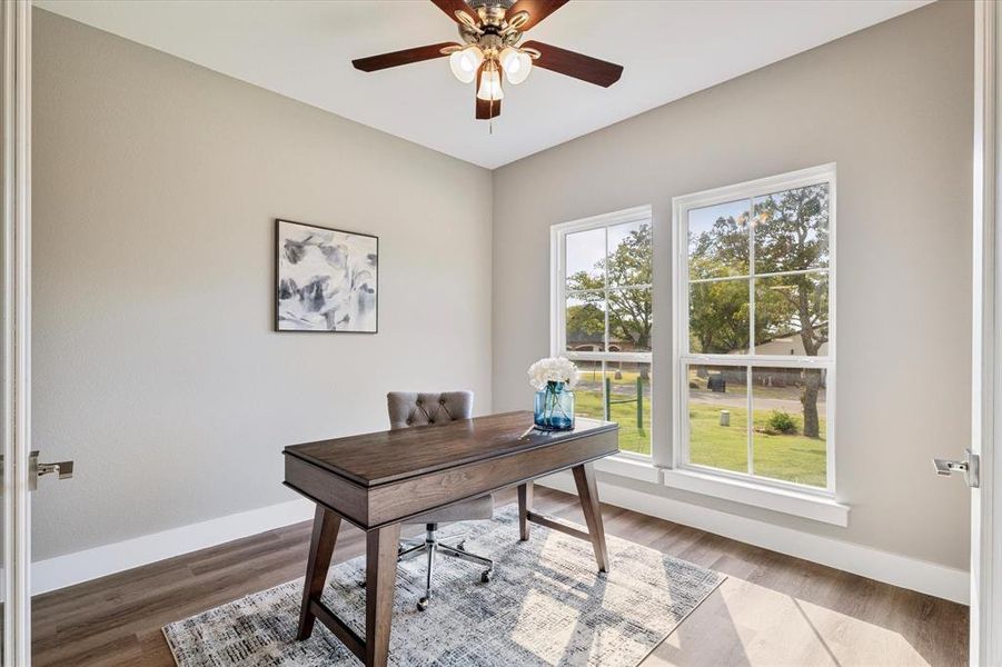 Office space with hardwood / wood-style flooring, a healthy amount of sunlight, and ceiling fan