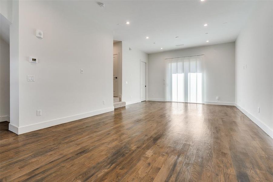 Living Room with Wood Floors and Access to the Private Balcony