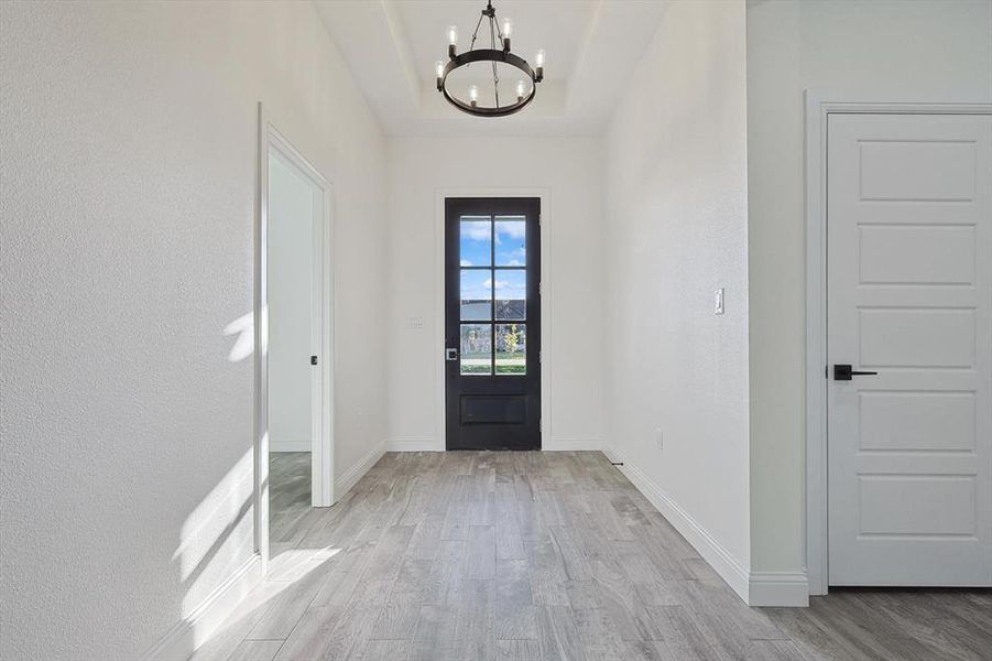 Entryway featuring a chandelier and light wood-type flooring