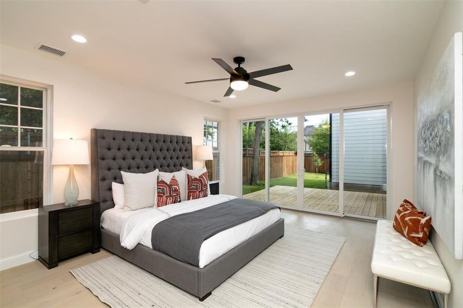 Bedroom featuring ceiling fan, access to outside, and light hardwood / wood-style flooring