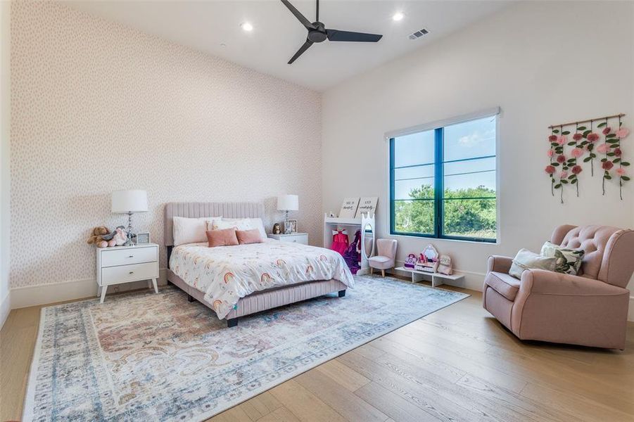 Bedroom featuring ceiling fan and wood-type flooring