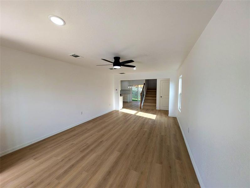 Unfurnished living room featuring light hardwood / wood-style flooring and ceiling fan