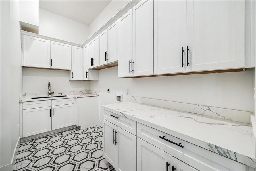 The first-floor laundry room is adjacent to the mudroom. Upstairs you'll find an additional area for stackable laundry